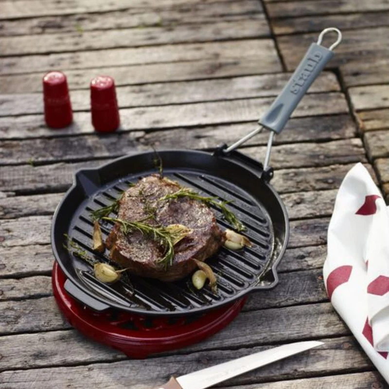 Parrilla redonda de hierro fundido con mango plegable Staub